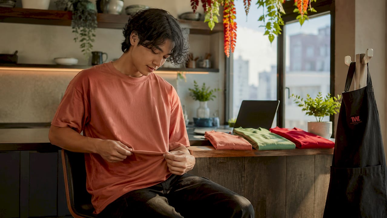Person feeling fabric of oversized t-shirt on couch